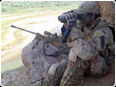 A sniper surveys the terrain during a task in Southern Afganistan.jpg